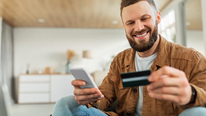 happy guy with credit card