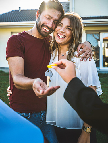 couple receiving key at house