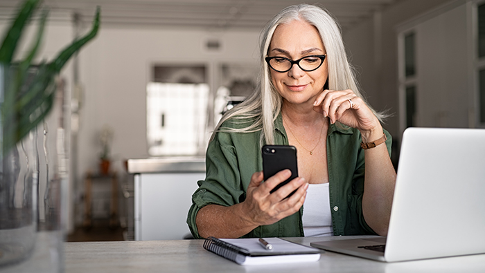 woman with phone and laptop