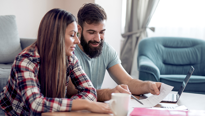 Couple with papers and laptop