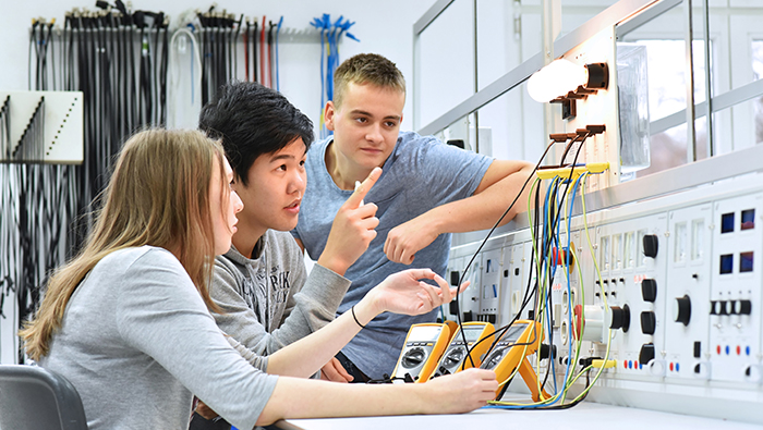 three students of electricity