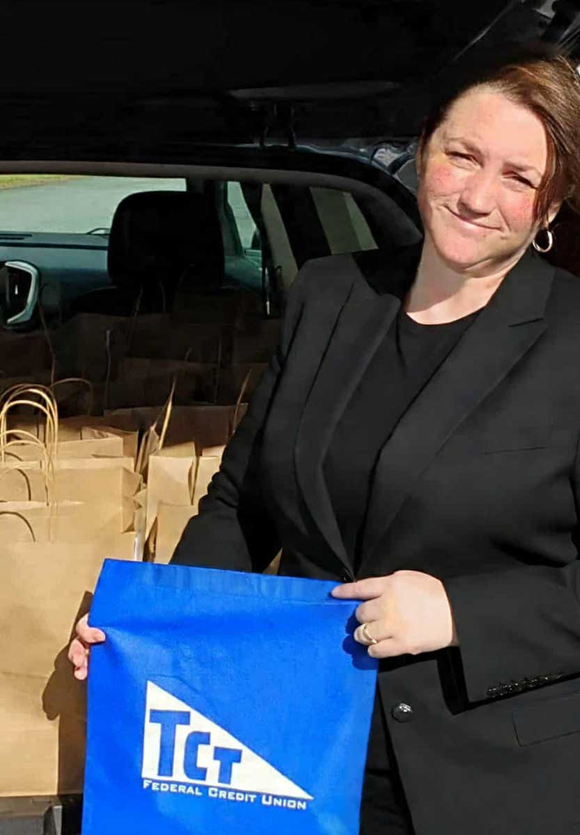 Jeannie Dickinson delivers a trunkful of food donations to the Cambridge Food Pantry.